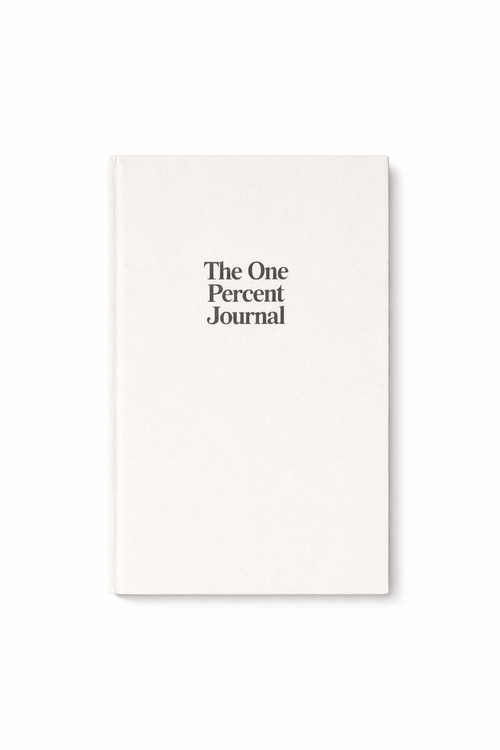 The One Percent Journal, an undated goal-setting and habit-tracking journal with a black cover